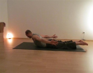 lift off legs, knees, head and outward rotated arms of the floor